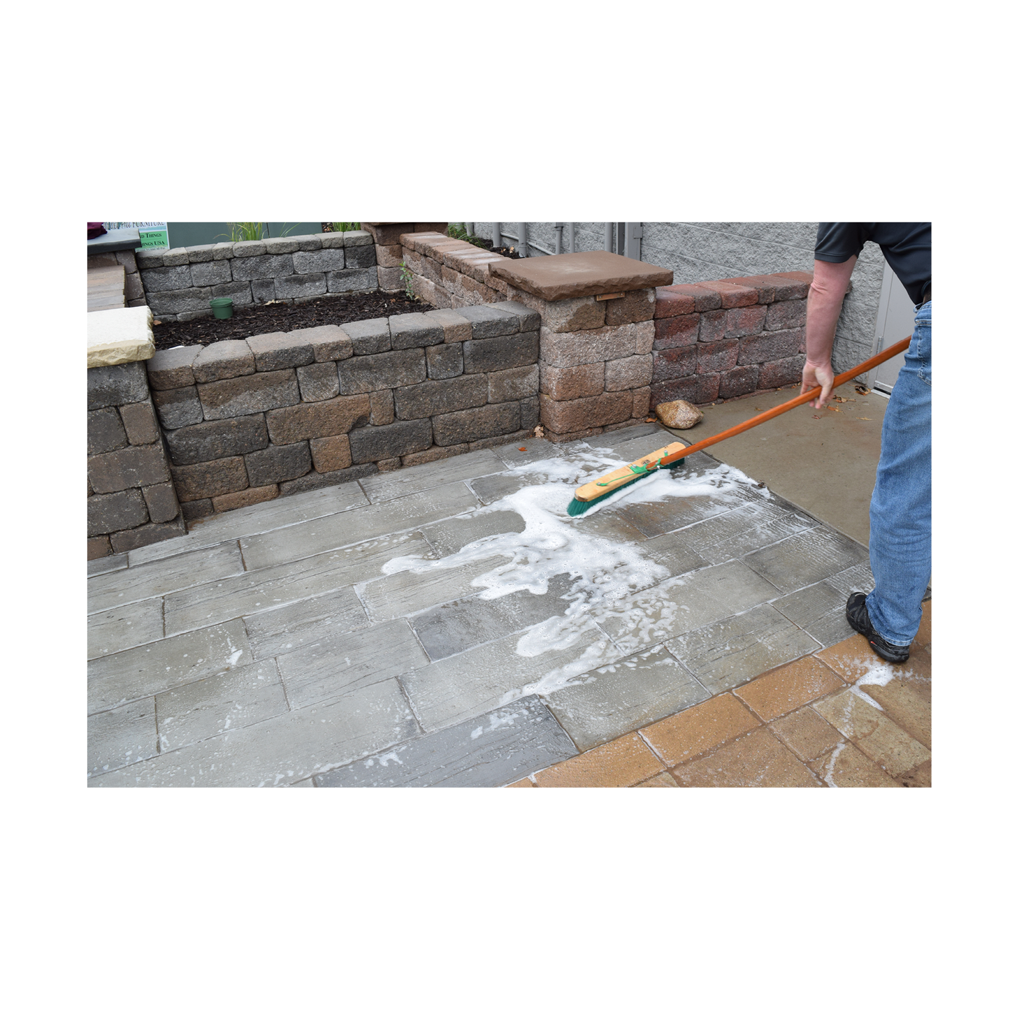 Scrubbing wetcast patio with cleaner