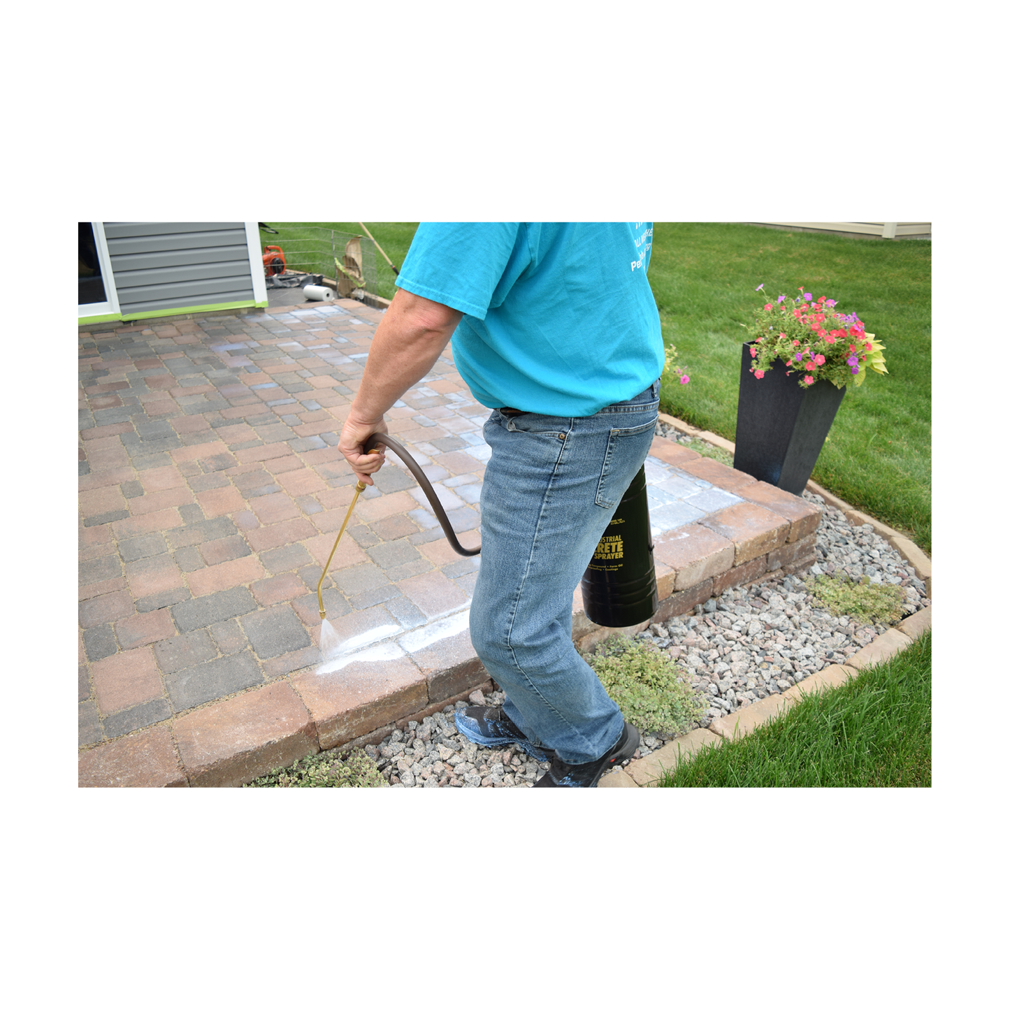 Spraying low gloss patio sealer with construction sprayer