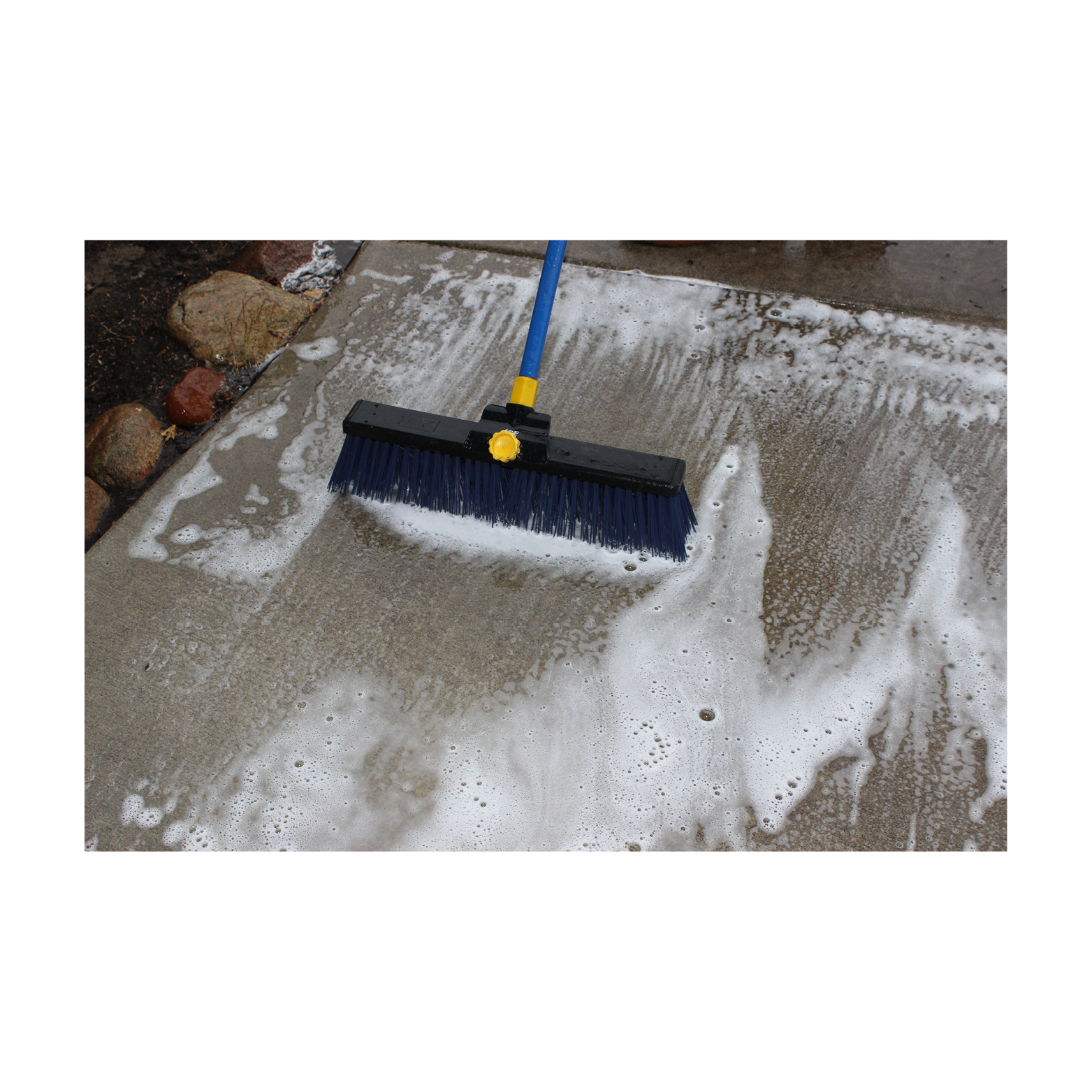 stain remover scrubbing on concrete pathway